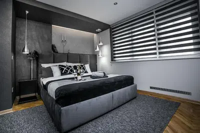 a bedroom with a large bed and a large window at Sinergija in Belgrade