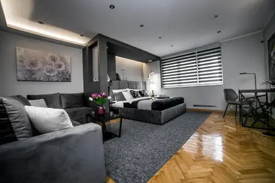 a living room with a couch and a bed at Sinergija in Belgrade