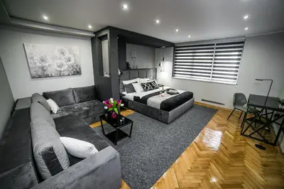 a living room with a couch and a bed at Sinergija in Belgrade