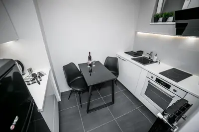 a small kitchen with a table and a sink at Sinergija in Belgrade
