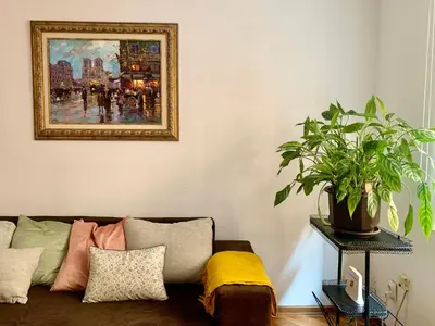 a living room with a couch and a painting on the wall at Star apartment 2 in Belgrade
