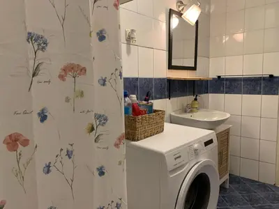a bathroom with a washing machine and a sink at Star apartment 2 in Belgrade