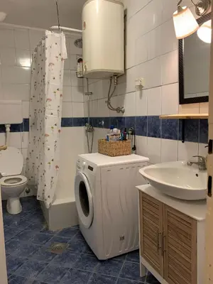 a bathroom with a washing machine and a sink at Star apartment 2 in Belgrade