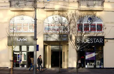 a building with people walking in front of a store at Dominic Smart & Luxury Suites - Terazije in Belgrade