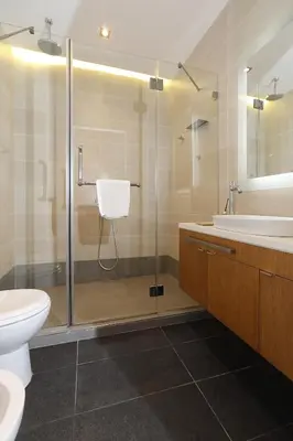 a bathroom with a shower and a toilet and a sink at Dominic Smart & Luxury Suites - Terazije in Belgrade