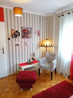 a living room with a chair and a table at Two Rivers Apartment in Belgrade