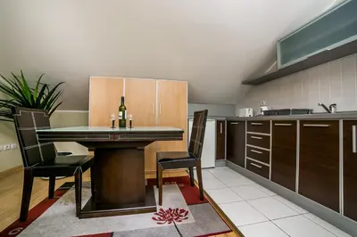 a kitchen with a table and chairs in a room at Residence Amelie in Belgrade
