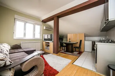 a small living room with a couch and a kitchen at Residence Amelie in Belgrade