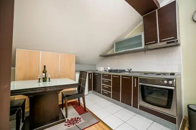 a kitchen with wooden cabinets and a counter top at Residence Amelie in Belgrade