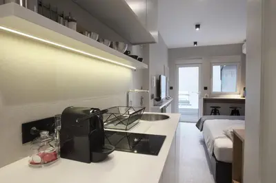 a kitchen with a black appliance on a counter at Temple Apartments Belgrade in Belgrade