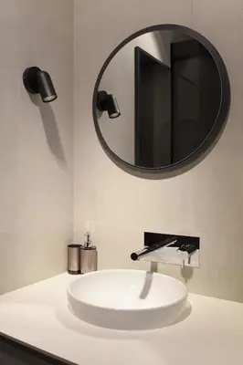 a bathroom with a white sink and a mirror at Temple Apartments Belgrade in Belgrade