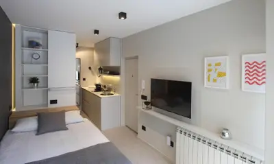 a living room with a flat screen tv on a wall at Temple Apartments Belgrade in Belgrade