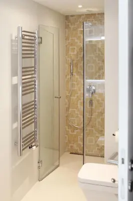 a bathroom with a glass shower with a toilet at Temple Apartments Belgrade in Belgrade