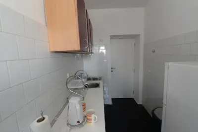 a small bathroom with a white tiled wall at OBILIĆ in Belgrade
