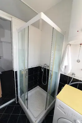a shower with a glass door in a bathroom at OBILIĆ in Belgrade