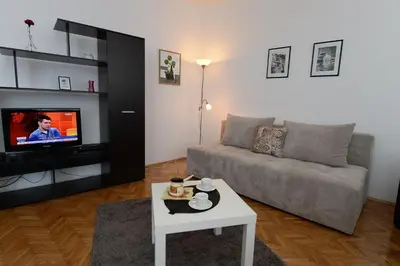 a living room with a couch and a tv at OBILIĆ in Belgrade