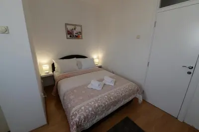 a bedroom with a bed with two towels on it at OBILIĆ in Belgrade