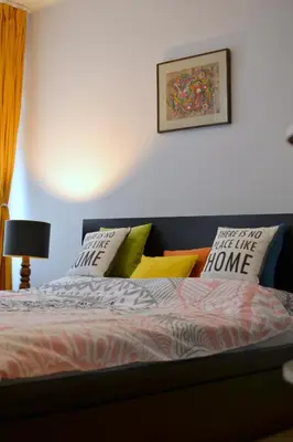 a bedroom with a bed with pillows on it at City Center Lovely Studio Apartment in Belgrade