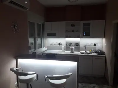 a kitchen with a counter and two stools in it at Apartment Centar Exclusive Smederevo in Smederevo