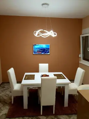 a dining room with a white table and white chairs at Apartment Centar Exclusive Smederevo in Smederevo