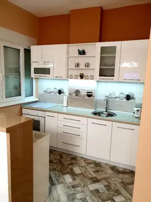 a kitchen with white cabinets and a sink at Apartment Centar Exclusive Smederevo in Smederevo