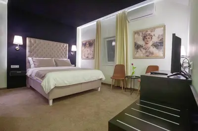 a bedroom with a bed and a television in it at 4Rooms 4U in Belgrade