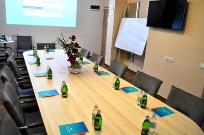 a conference room with a long table with bottles on it at Hotel Mar Garni in Belgrade