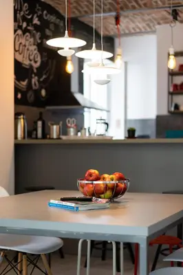 a bowl of fruit on a table in a kitchen at Good People Design Hostel in Belgrade