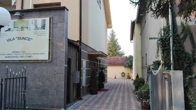 an alley with a sign on the side of a building at Hotel Vila Sunce in Stara Pazova