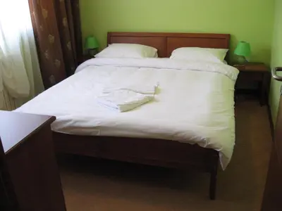 a bed with two white towels on top of it at Hotel Vila Sunce in Stara Pazova