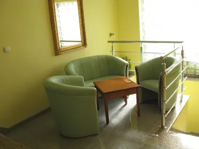 a waiting room with two chairs and a table at Hotel Vila Sunce in Stara Pazova