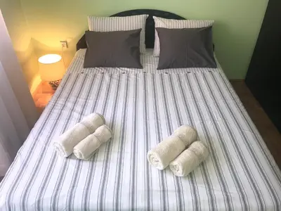 a bed with three pillows on top of it at Apartman AS in Belgrade