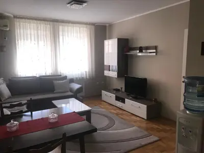 a living room with a couch and a tv at Apartman AS in Belgrade