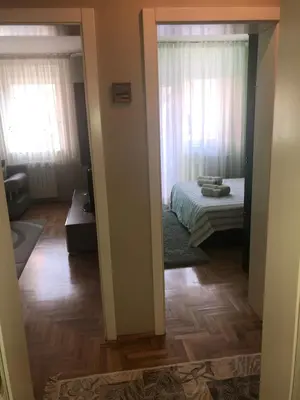a view of a bedroom with a bed and a mirror at Apartman AS in Belgrade