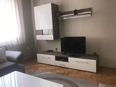 a living room with a flat screen tv and a couch at Apartman AS in Belgrade