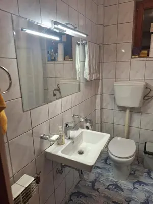 a bathroom with a white sink and a toilet at NOBLES APARTMENT 4**** in Belgrade