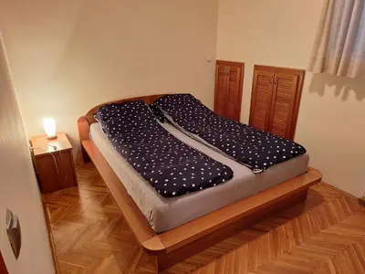 a bed in a room with a wooden floor at NOBLES APARTMENT 4**** in Belgrade
