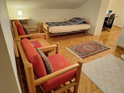 a living room with chairs and a bed and a rug at NOBLES APARTMENT 4**** in Belgrade