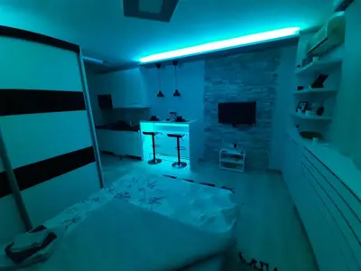 a dark room with a bed and a desk at Victoria in Vračar (historical)
