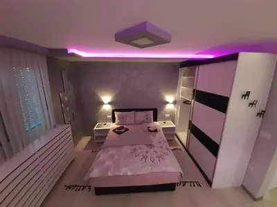 a bedroom with a bed and a purple lighting at Victoria in Vračar (historical)