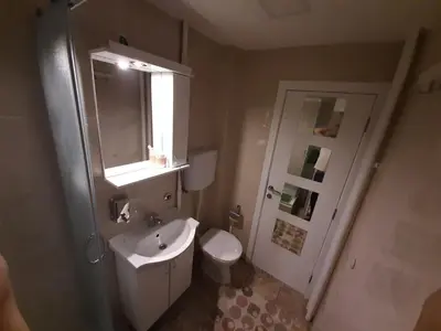 a bathroom with a sink and a toilet and a window at Victoria in Vračar (historical)