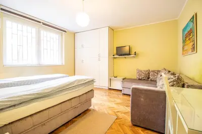 a bedroom with a bed and a couch at Captain's Crib in Belgrade