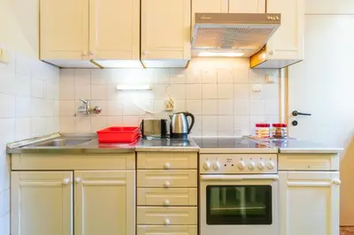 a kitchen with a sink and a stove at Captain's Crib in Belgrade