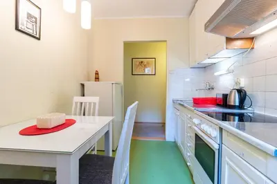 a kitchen with a table and a table and chairs at Captain's Crib in Belgrade