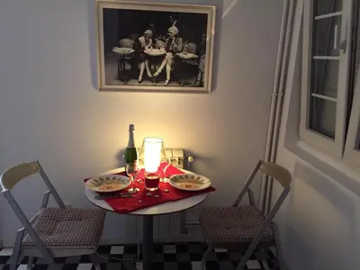 a table with a candle and a bottle of wine at Apartment Treci in Belgrade