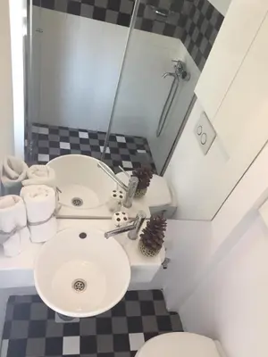 a bathroom with a sink and a toilet and a shower at Apartment Treci in Belgrade