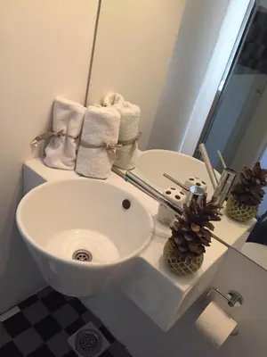 a bathroom with a white sink and a mirror at Apartment Treci in Belgrade