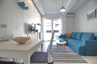 a living room with a table and a blue couch at Bianca in Belgrade