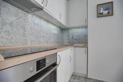 a kitchen with white cabinets and a sink at Bianca in Belgrade