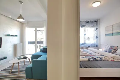 a bedroom with a bed and a couch and a table at Bianca in Belgrade